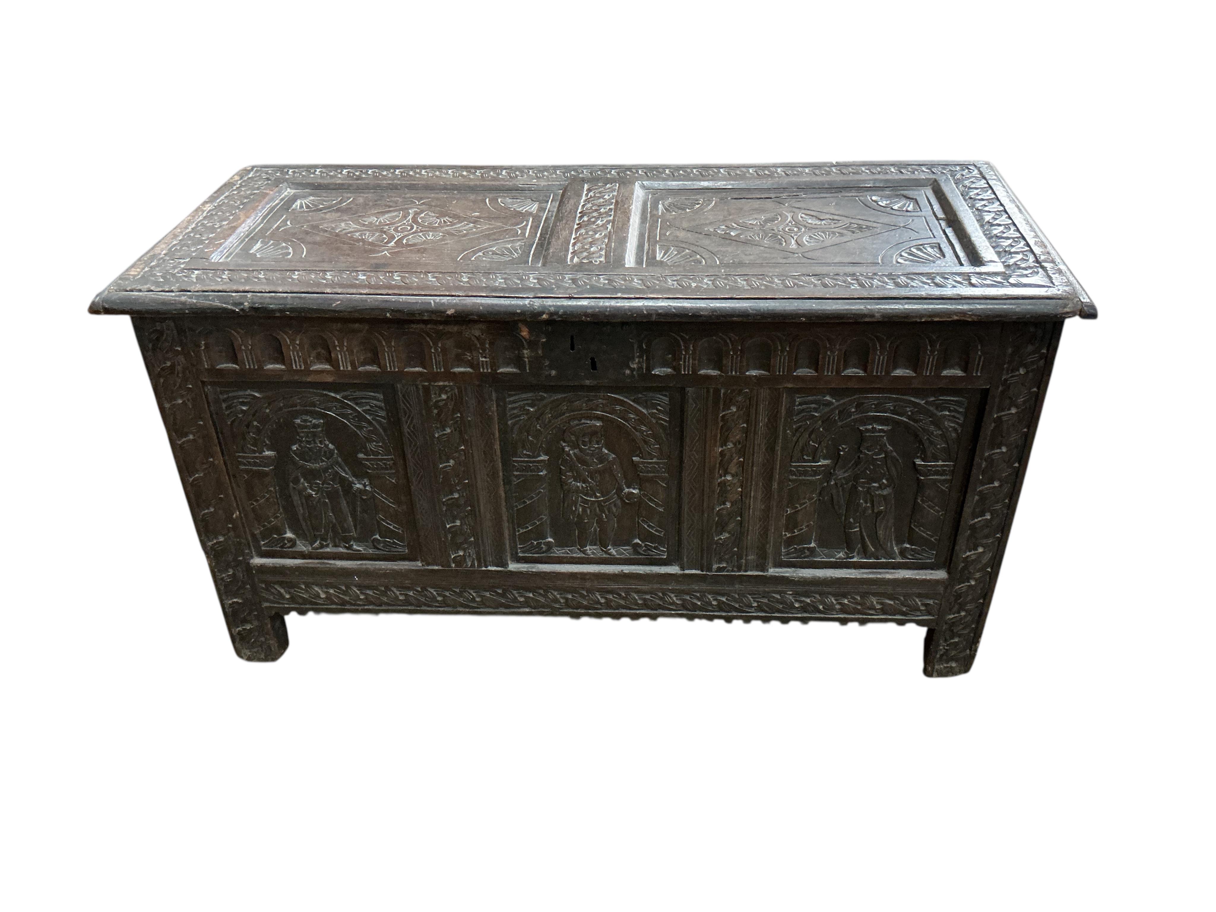 An 18th century oak panelled coffer, later carved, width 116cm, depth 49cm, height 64cm
